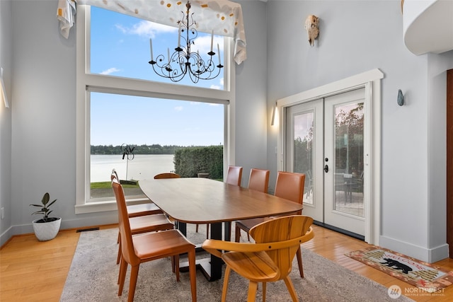 7342 Huckleberry Rd NW, Olympia, WA 98502 - dining room featuring plenty of natural light, light wood-type flooring, and a high ceiling