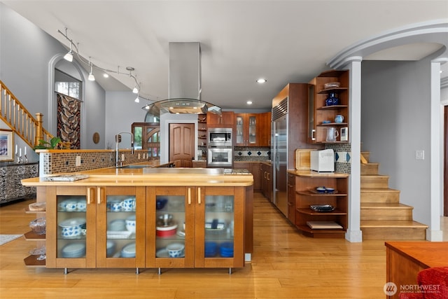 7342 Huckleberry Rd NW, Olympia, WA 98502 - kitchen featuring open shelves, a sink, built in appliances, island range hood, and recessed lighting