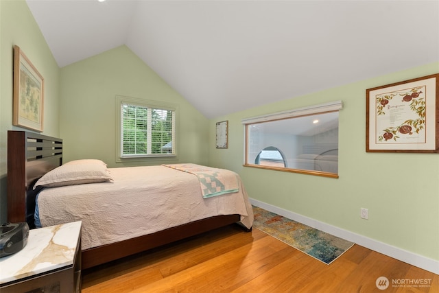 7342 Huckleberry Rd NW, Olympia, WA 98502 - bedroom with wood finished floors, vaulted ceiling, and baseboards