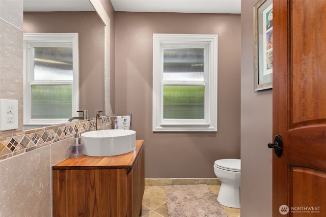 7342 Huckleberry Rd NW, Olympia, WA 98502 - bathroom with vanity, toilet, baseboards, and plenty of natural light