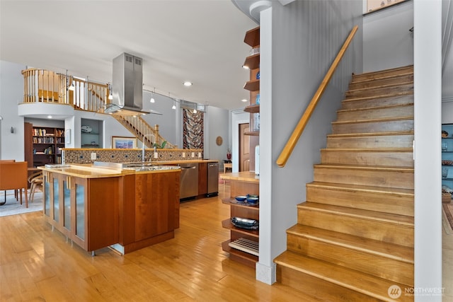 7342 Huckleberry Rd NW, Olympia, WA 98502 - kitchen featuring open shelves, island exhaust hood, stainless steel dishwasher, light wood-style flooring, and a large island