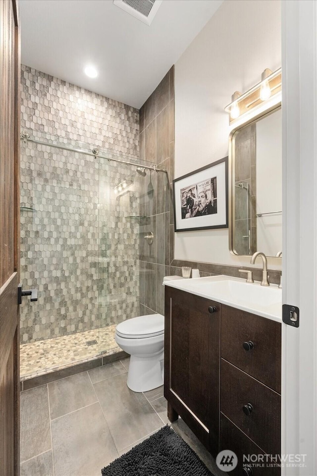 381 Pebble Beach Dr, Cle Elum, WA 98922 - bathroom with a stall shower, toilet, vanity, and tile patterned floors