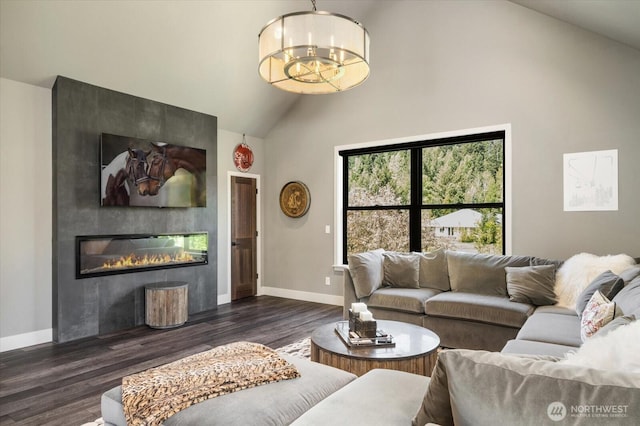 381 Pebble Beach Dr, Cle Elum, WA 98922 - living room with high vaulted ceiling, wood finished floors, a fireplace, baseboards, and a chandelier