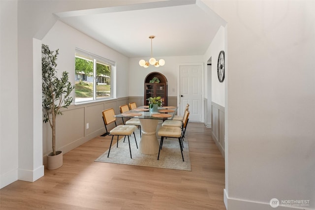 2707 Angel Ln, East Wenatchee, WA 98802 - dining space with light wood-type flooring, wainscoting, and a chandelier