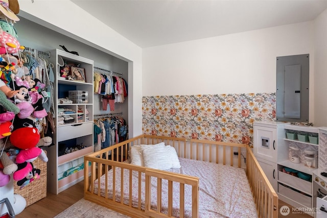 2707 Angel Ln, East Wenatchee, WA 98802 - bedroom featuring electric panel, wallpapered walls, and wood finished floors