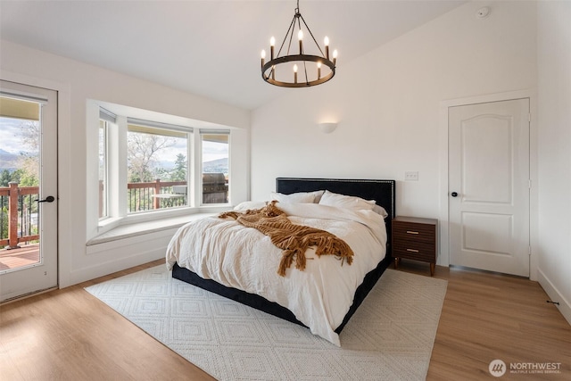 2707 Angel Ln, East Wenatchee, WA 98802 - bedroom featuring access to outside, a chandelier, wood finished floors, and high vaulted ceiling