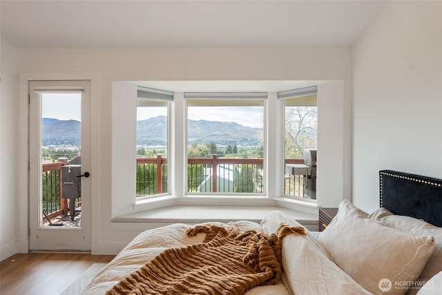 2707 Angel Ln, East Wenatchee, WA 98802 - bedroom featuring access to exterior, a mountain view, multiple windows, and wood finished floors