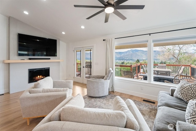 2707 Angel Ln, East Wenatchee, WA 98802 - living room featuring a mountain view, a ceiling fan, recessed lighting, vaulted ceiling, and a glass covered fireplace