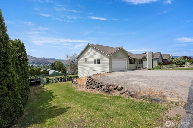 2707 Angel Ln, East Wenatchee, WA 98802 - view of side of property with gravel driveway, an attached garage, and a mountain view