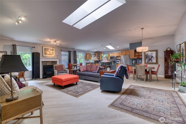 157 Northwood Dr, Point Roberts, WA 98281 - living room with healthy amount of natural light, a chandelier, a tiled fireplace, and a skylight