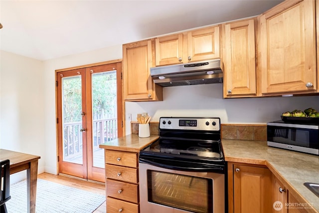 9514 Sand Point Way NE, Seattle, WA 98115 - kitchen with stainless steel electric stove, under cabinet range hood, french doors, light countertops, and light wood-style flooring