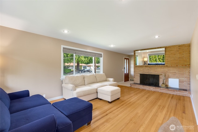 229 S 171st St, Burien, WA 98148 - living room featuring a fireplace, light wood-style flooring, recessed lighting, and baseboards