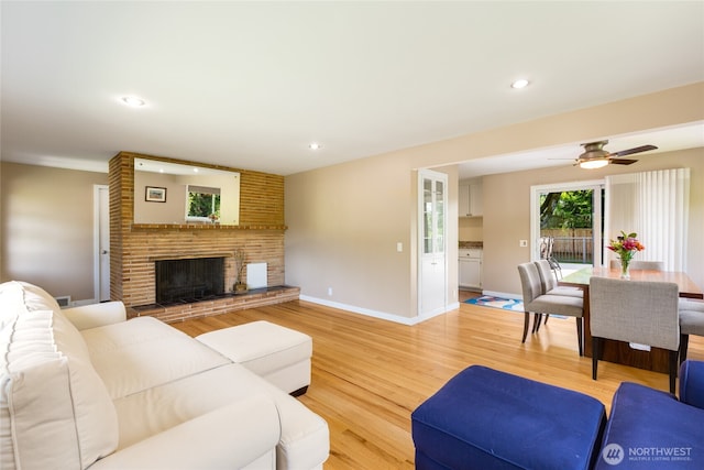 229 S 171st St, Burien, WA 98148 - living area with light wood finished floors, a brick fireplace, a ceiling fan, baseboards, and recessed lighting