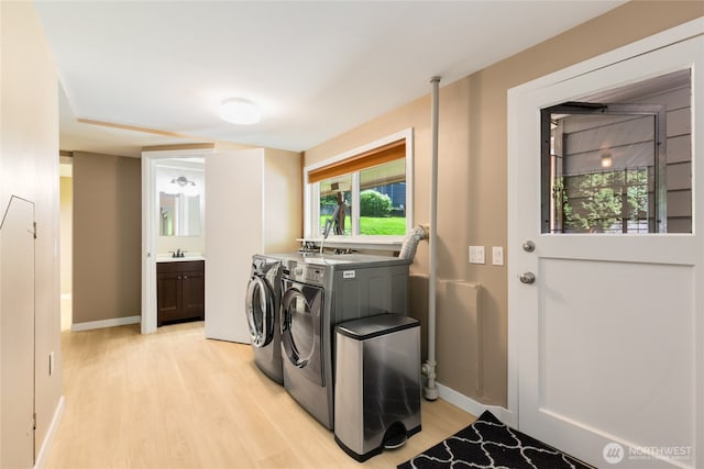 229 S 171st St, Burien, WA 98148 - washroom with washer and dryer, light wood-style floors, and baseboards