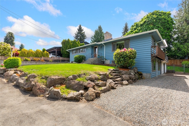 229 S 171st St, Burien, WA 98148 - view of front of house featuring a chimney, gravel driveway, and a balcony