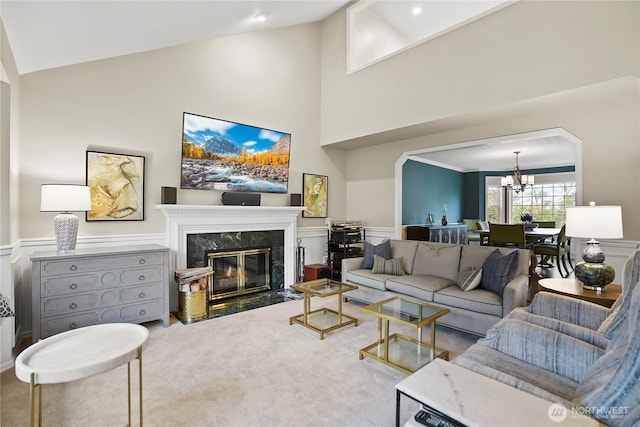 2601 59th St SW, Everett, WA 98203 - living room with a chandelier, a fireplace, wainscoting, high vaulted ceiling, and a decorative wall