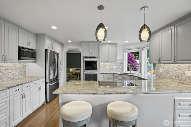 2601 59th St SW, Everett, WA 98203 - kitchen featuring appliances with stainless steel finishes, a sink, dark wood-style flooring, decorative backsplash, and recessed lighting