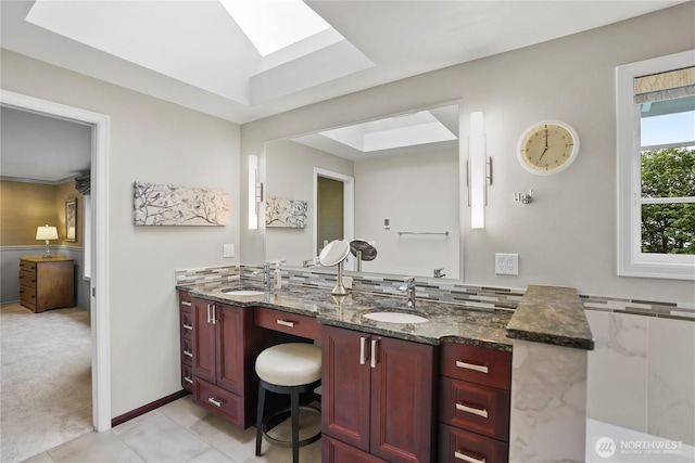 2601 59th St SW, Everett, WA 98203 - full bathroom featuring a skylight, double vanity, tile patterned floors, and baseboards