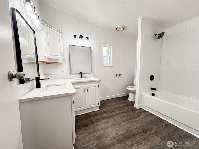 700 N Reed St Unit 72, Sedro Woolley, WA 98284 - full bath with crown molding, two vanities, wood finished floors, toilet, and washtub / shower combination