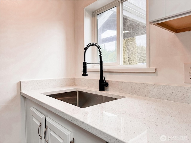 700 N Reed St Unit 72, Sedro Woolley, WA 98284 - kitchen view of a sink, light stone countertops, and white cabinetry