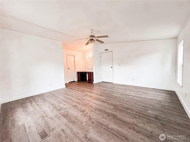 700 N Reed St Unit 72, Sedro Woolley, WA 98284 - unfurnished living room with a ceiling fan, wood finished floors, and baseboards