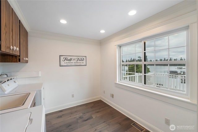 4217 Lakeridge Dr E, Lake Tapps, WA 98391 - laundry room featuring cabinet space, washing machine and clothes dryer, dark wood-style flooring, baseboards, and recessed lighting