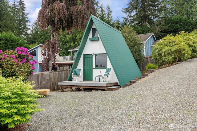 4217 Lakeridge Dr E, Lake Tapps, WA 98391 - view of front of property with fence, an outdoor structure, metal roof, and view of scattered trees