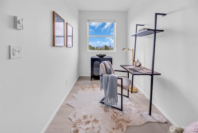home office featuring baseboards and wood finished floors