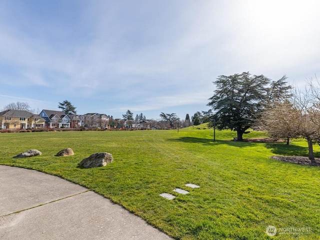 view of home's community with a lawn and a residential view