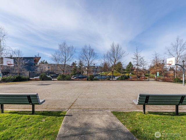 view of home's community with community basketball court, uncovered parking, and fence