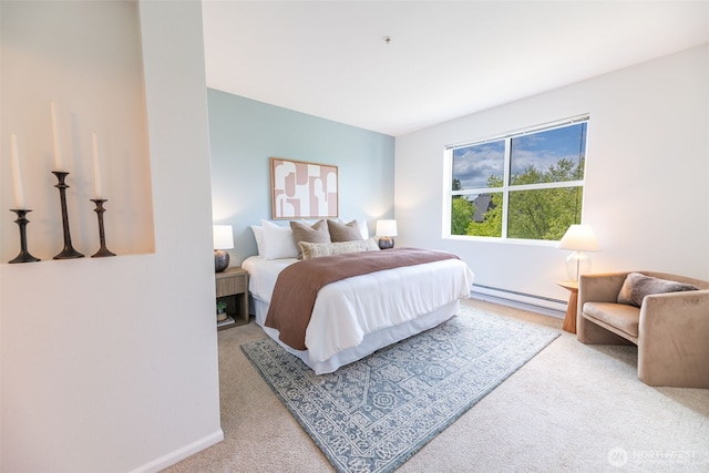 bedroom with carpet flooring, a baseboard heating unit, and baseboards