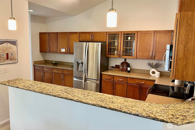 2980 SW Raymond St Unit 301, Seattle, WA 98126 - kitchen with appliances with stainless steel finishes, brown cabinets, glass insert cabinets, light stone countertops, and lofted ceiling