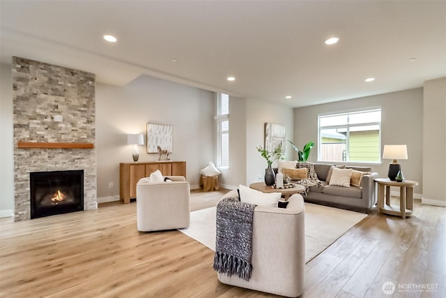 16001 1st Ave NE, Duvall, WA 98019 - living room featuring wood finished floors, recessed lighting, a stone fireplace, and baseboards