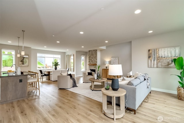 16001 1st Ave NE, Duvall, WA 98019 - living room with light wood-style floors, recessed lighting, a stone fireplace, and baseboards