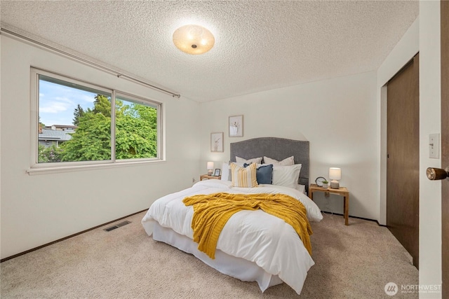 carpeted bedroom with a textured ceiling