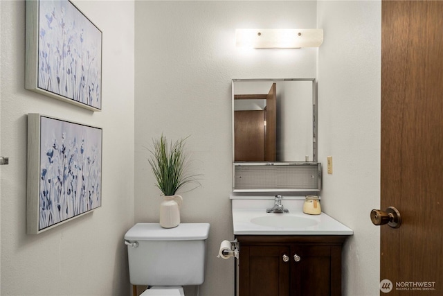 bathroom featuring toilet and vanity