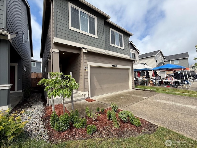 18708 108th Ave SE, Puyallup, WA 98374 - view of front facade featuring a garage and concrete driveway