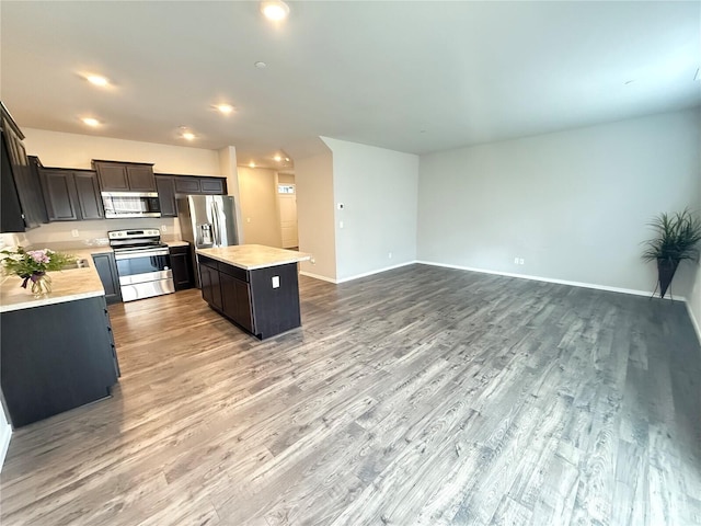 18708 108th Ave SE, Puyallup, WA 98374 - kitchen with stainless steel appliances, a center island, light countertops, light wood-style flooring, and recessed lighting