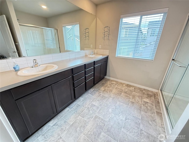 18708 108th Ave SE, Puyallup, WA 98374 - bathroom with plenty of natural light, a shower stall, baseboards, and double vanity