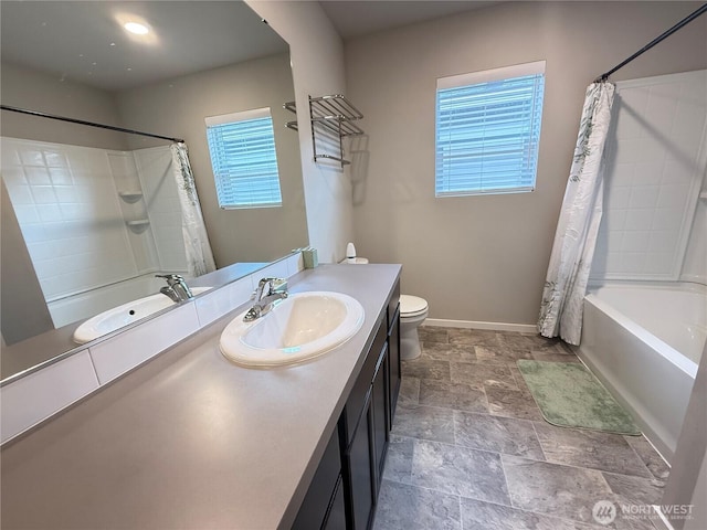 18708 108th Ave SE, Puyallup, WA 98374 - bathroom featuring toilet, shower / tub combo with curtain, stone finish floors, vanity, and baseboards