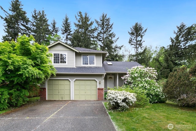 view of front of property with an attached garage, asphalt driveway, and brick siding