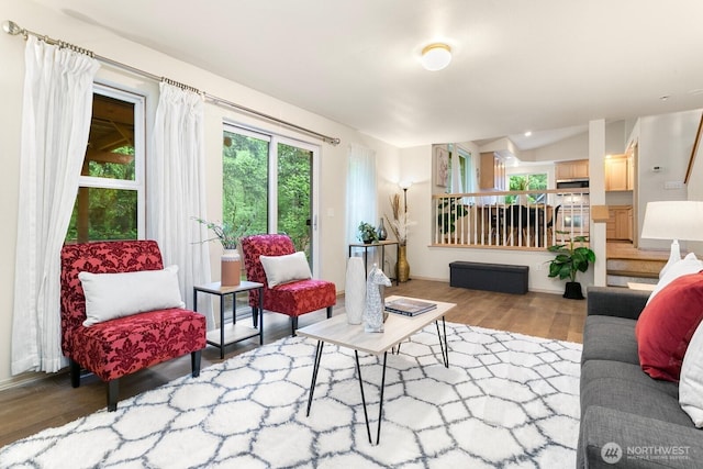 living room featuring wood finished floors and stairs
