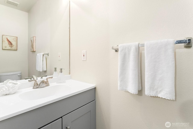 bathroom with vanity and toilet