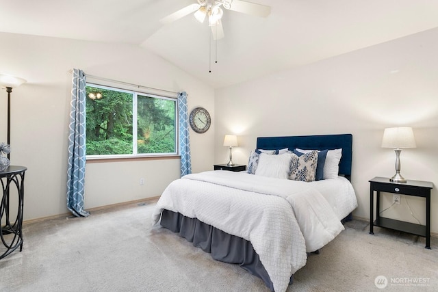 carpeted bedroom with lofted ceiling, baseboards, and a ceiling fan