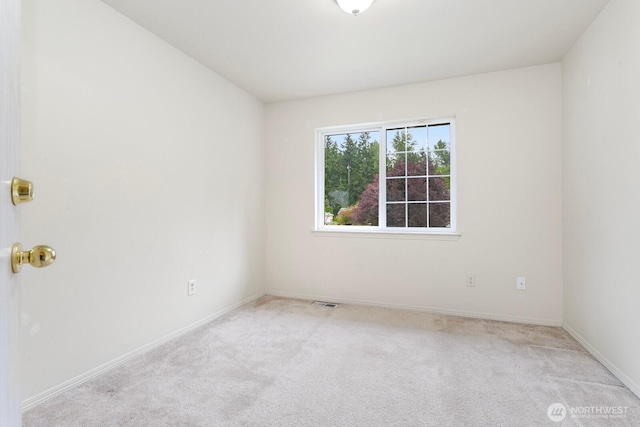 carpeted spare room with baseboards