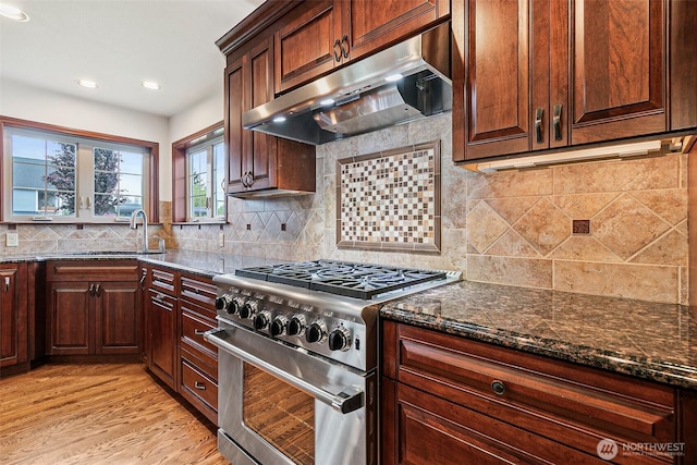 16915 32nd Ave E, Tacoma, WA 98446 - kitchen featuring stainless steel range, under cabinet range hood, dark stone counters, tasteful backsplash, and recessed lighting