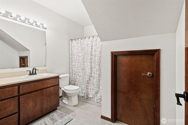 16915 32nd Ave E, Tacoma, WA 98446 - bathroom featuring toilet, vanity, and a shower with shower curtain