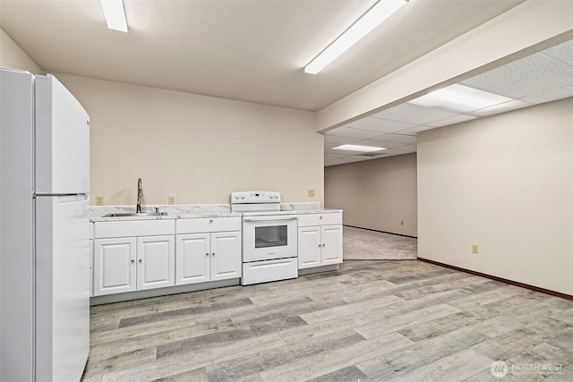 16915 32nd Ave E, Tacoma, WA 98446 - kitchen with white appliances, a sink, white cabinetry, light countertops, and light wood-type flooring