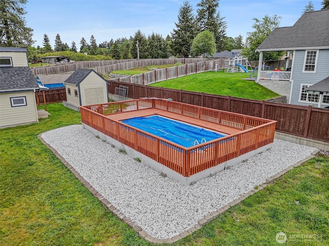 16915 32nd Ave E, Tacoma, WA 98446 - view of swimming pool featuring a playground, a storage shed, and an outdoor structure