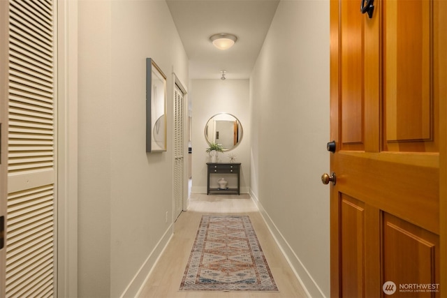 120 Hall Brothers Loop NW Unit 103, Bainbridge Island, WA 98110 - hallway featuring a heating unit, wood finished floors, and baseboards